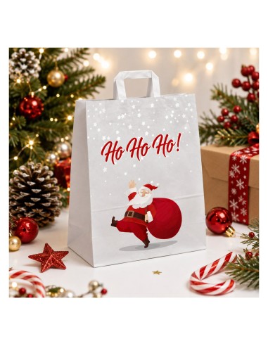 Sac kraft blanc Père Noël entouré de boules de Noël et de sucres d'orge