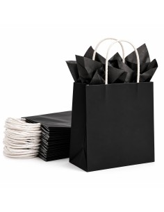 sac en papier kraft noir garni de papier de soie noir, devant un paquet de sacs pliés