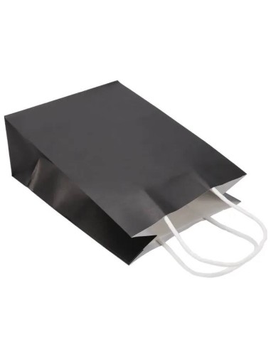 poignées torsadées blanches collées à l'intérieur d'un sac en papier kraft noir